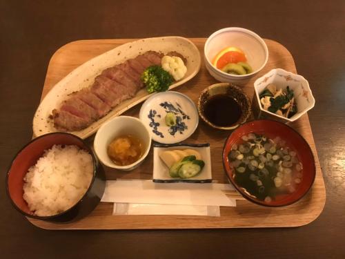a tray of food with meat rice and vegetables at Kinugawa Pension Bamboo in Nikko
