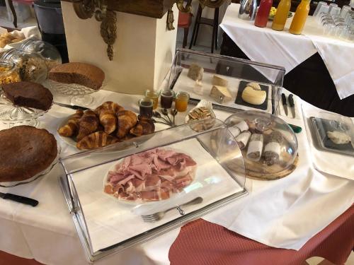 a table with a plate of pastries and other foods at Locanda Dell' Orso Bevitore in Verduno