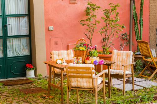 a table and chairs with flowers on a patio at Frascati Country House in Grottaferrata