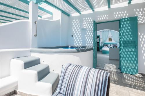 a living room with a staircase and a couch at Anastasia Princess Luxury Beach Residence, Adults Only in Perissa