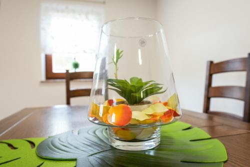 a glass vase filled with fruit on a table at Wineyard getaway house in Sevnica