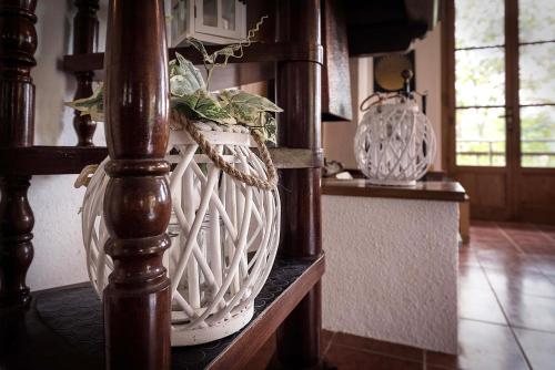 a white basket with a plant in it on a shelf at Casa Ermo Colle in Sant'Ermo