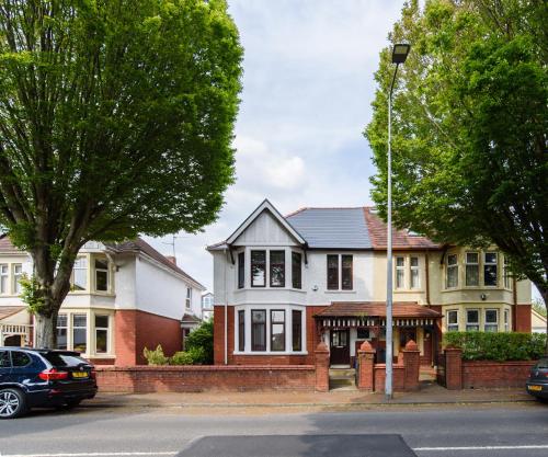 a house on the corner of a street at City Retreat, Spacious 4 Bed House, Games Room, Parking, Hot Tub & BBQ in Cardiff