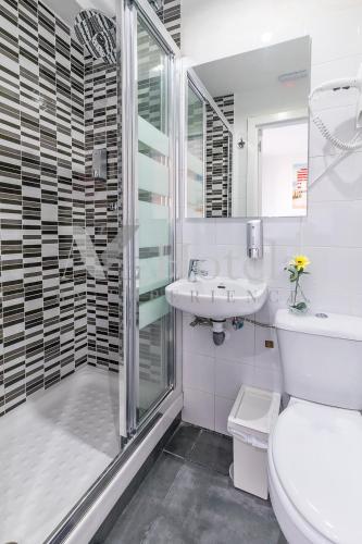 a bathroom with a toilet and a sink and a shower at AYZ Sierra de Meira - Auto check-in property in Madrid