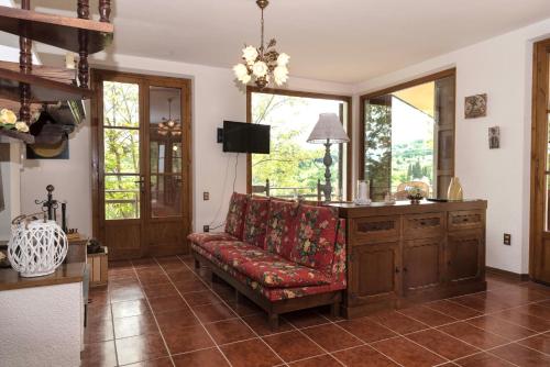 a living room with a couch and a window at Casa Ermo Colle in Sant'Ermo