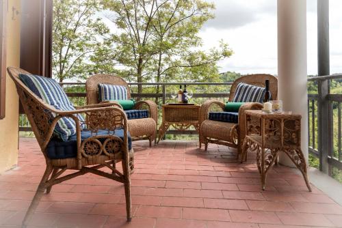 a group of chairs and a table on a porch at Casa Ermo Colle in Sant'Ermo