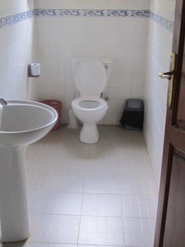 a bathroom with a toilet and a sink at JoysVilla Family Holiday Home in Malindi