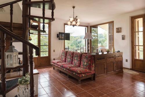 a living room with a red couch and a staircase at Casa Ermo Colle in Sant'Ermo