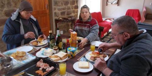 a group of people sitting around a table eating food at MacFarlanes in Harrismith