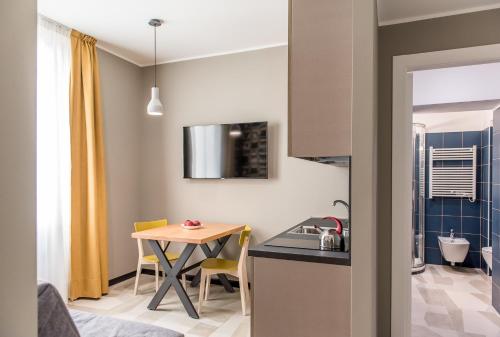 a small kitchen with a table and a small dining room at APARTHOTEL CASA MIA in Milan