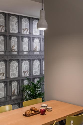 a dining room table with a plate of food on it at APARTHOTEL CASA MIA in Milan