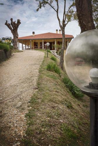 a house with a large silver ball in front of it at Casa Ermo Colle in Sant'Ermo