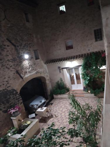 a living room with a fireplace in a stone building at Le Térébinthe B&B in Lauris