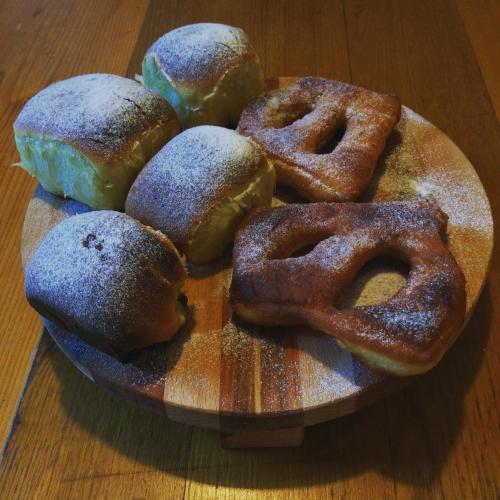 a plate of donuts on a wooden table at Tourist Farm Strle With Great Local Food in Cerknica