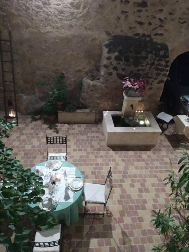 a patio with a table and chairs and a sink at Le Térébinthe B&B in Lauris