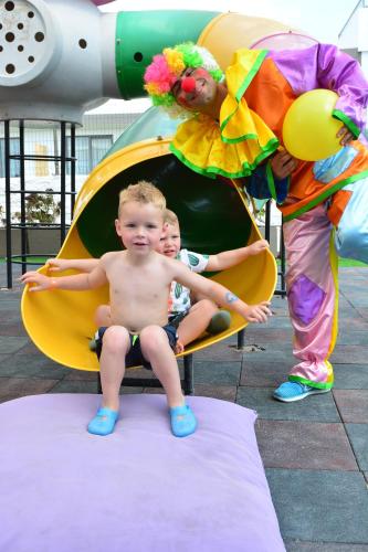 two children sitting in a slide with a clown at Parkim Ayaz Hotel in Gümbet