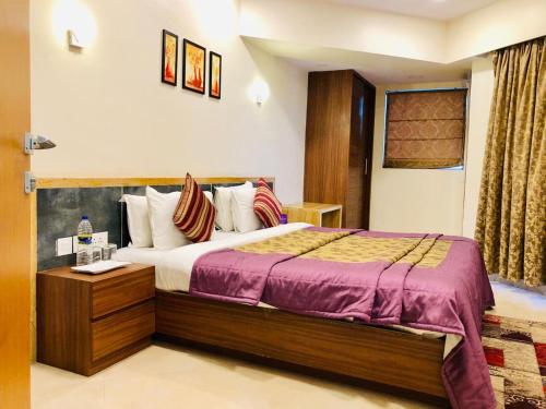 a bedroom with a large bed in a room at VITS Kamats Resort, Silvassa in Silvassa