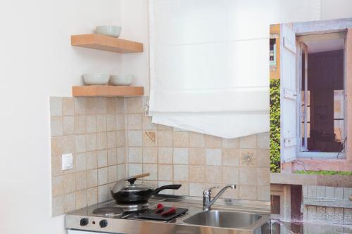 a kitchen with a sink and a pot on the stove at Thalassa Apartments in Nydri