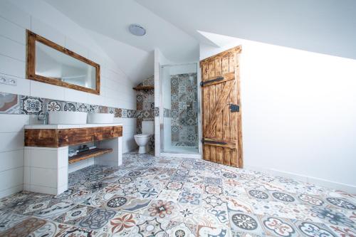 a bathroom with a toilet and a sink and a door at Penzion Šarlota & Vinařství Vítek Josef in Mutěnice