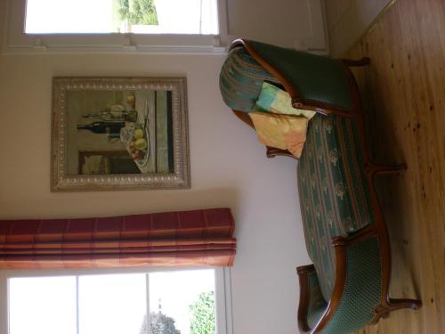 a curtain hanging on a wall next to a window at LA VIGNERAIE - SARL Champ Potard in Fuissé