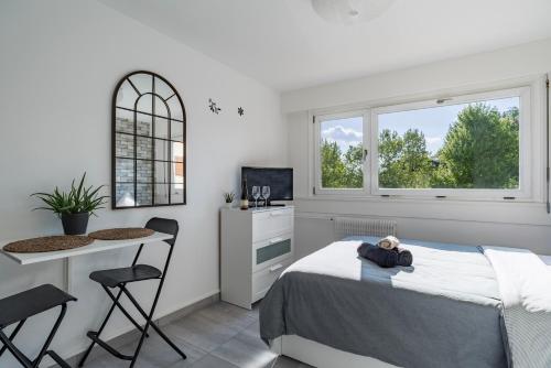a bedroom with a bed and a table and chairs at The Place-Studio in Schiltigheim