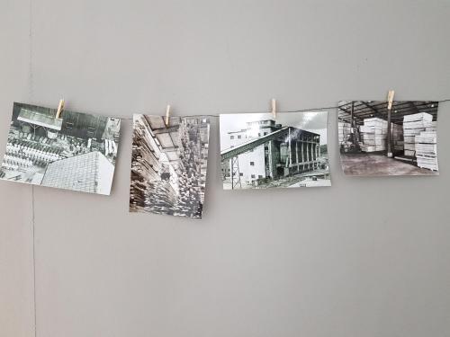 a group of photographs hanging on a wall at Brukshotellet Skinnsberg in Skinnskatteberg