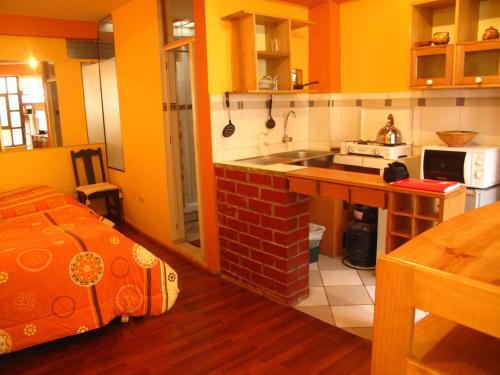 a kitchen with a sink and a stove in it at Casa De Mama Cusco - The Treehouse in Cusco