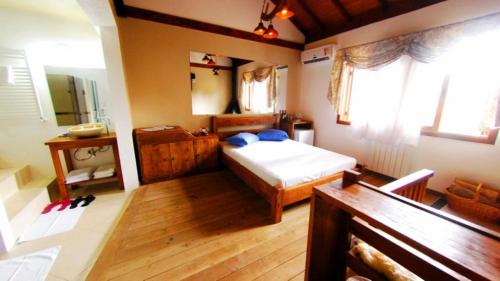 a bedroom with a bed and a wooden floor at Motel Tentação (Adult Only) in Canela