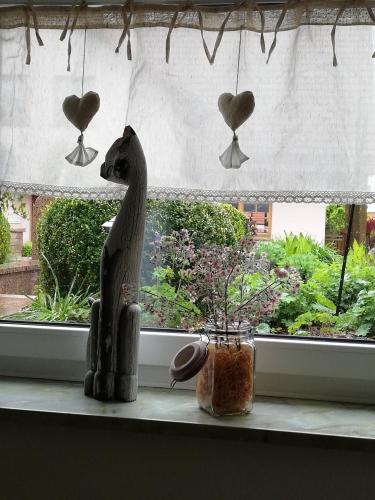 a statue of a horse sitting on a window sill at idylische Ferienwohnung in Schollbrunn