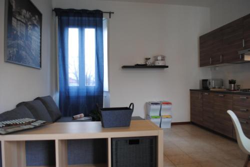 a living room with a couch and a table at Bnbook Cascina Crennese in Gallarate