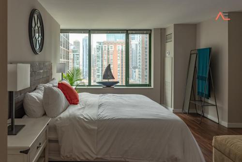 ein Schlafzimmer mit einem großen Bett und einem großen Fenster in der Unterkunft ENVITAE 3BR Downtown Luxurious Suite Views & Pool in Chicago