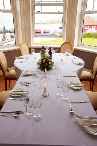 a table with wine glasses and napkins on it at Royal Valentia Hotel in Valentia Island
