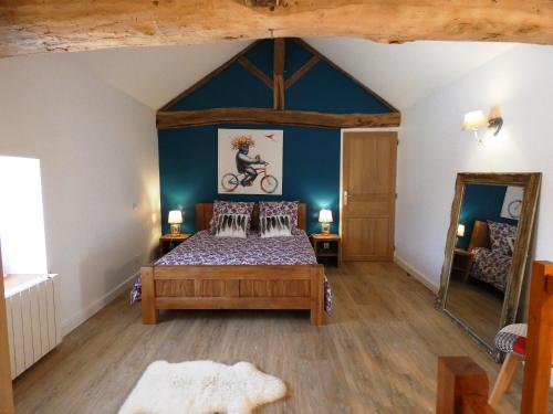 a bedroom with a bed and a bike on the wall at Le Clos De Quintaine Gîtes de Charme in Clessé