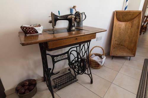 a sewing machine sitting on a table in a room at Samareitidos Light Cottage in Anaphotia