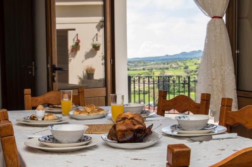 a table with plates of food on top of it at Samareitidos Light Cottage in Anaphotia