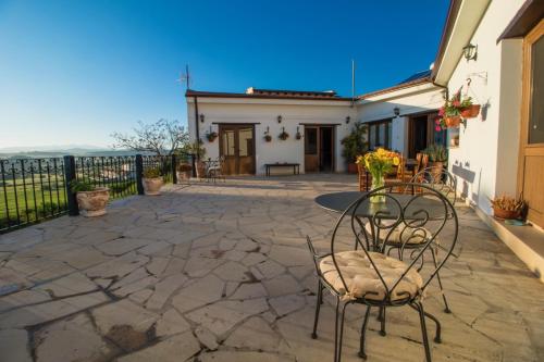 a patio with chairs and a table in a building at Samareitidos Light Cottage in Anaphotia