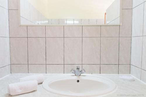 a bathroom with a sink and a mirror at Sunset Bay Club & SeaSide Resort in Salisbury