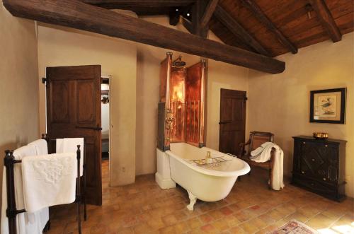 a bathroom with a bath tub in a room at Château de Bagnols in Bagnols