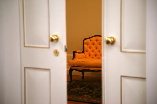 an orange chair sitting in front of a door at Casa Manuel Espregueira e Oliveira in Viana do Castelo