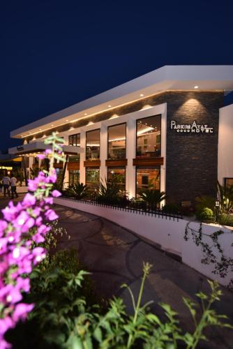 a building with purple flowers in front of it at Parkim Ayaz Hotel in Gümbet