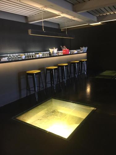 a bar with stools and a table in a room at Hotel Terme Neronensis in Pozzuoli