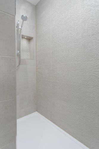 a shower with a glass door in a bathroom at The Alexander - Donnini Deluxe in Prestwick