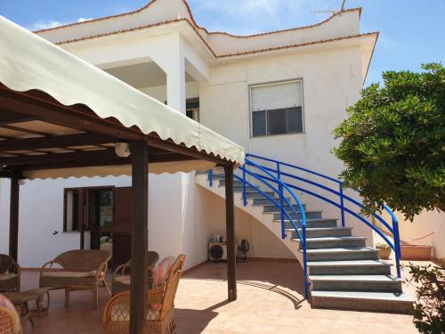 a house with a blue staircase in front of it at Da Giacomina in Marausa