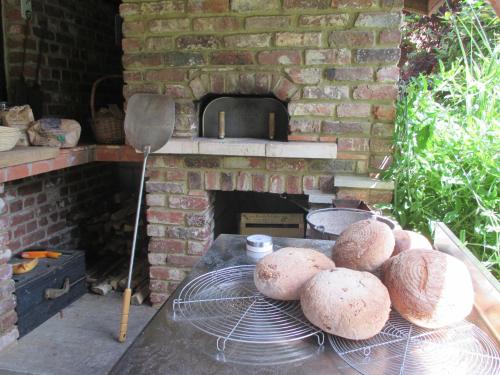 a brick oven with a bunch of loaves of bread at L'air pur 1 in Roisin