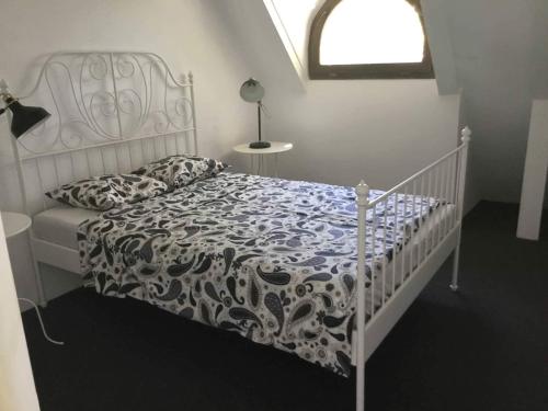 a white bed with a black and white comforter at Casa Thea Cheile Nerei in Socolari