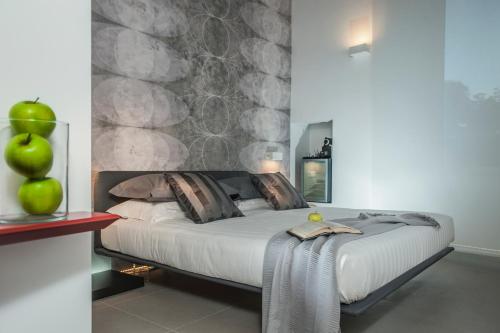 a bedroom with a bed with a stone wall at B&B First Floor in Rome