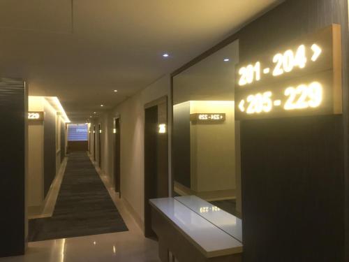 a hallway in a building with a clock on the wall at Hotel Expo Abastos in Guadalajara