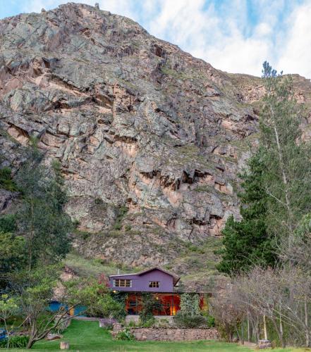 a small house in front of a mountain at Casa de La Chola in Ollantaytambo