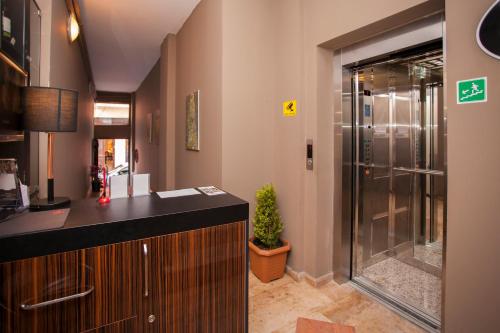 a bathroom with a shower and a sink and a counter at Hotel Belvedere in Batumi