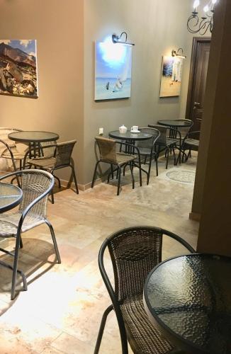 a group of tables and chairs in a room at Hotel Belvedere in Batumi